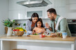 © ivanko80 - Playful Cook with Child Slicing Vegetables for Salad