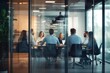 © 为轩 张 - Business team collaborating around a table in a modern office, captured through glass walls, planning for success with a blurred effect that adds dynamic movement, emphasizing teamwork and strategy.