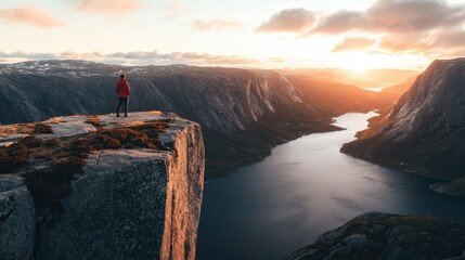 Poster - Person Standing on Cliff Edge Looking at Sunset over Fjord.