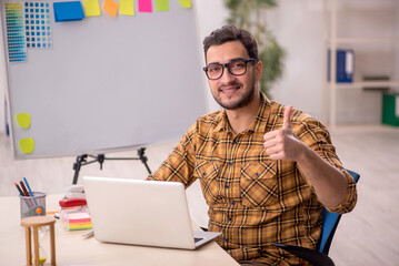 Wall Mural - Young male designer working in the office