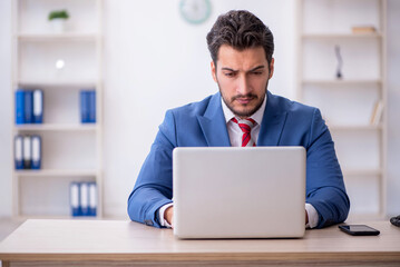 Poster - Young male employee working in the office