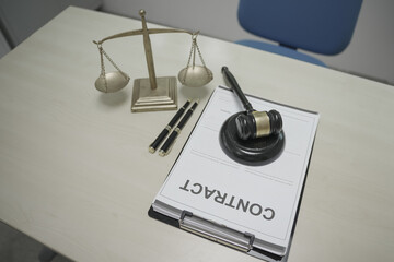 Wall Mural - Lawyer desk displays key legal objects, scales of justice, a gavel, and a paper contract. No people are present, but the scene suggests ongoing legal services and visa processing.