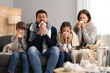 Canvas Print - Cold symptom. Family suffering from fever on sofa at home