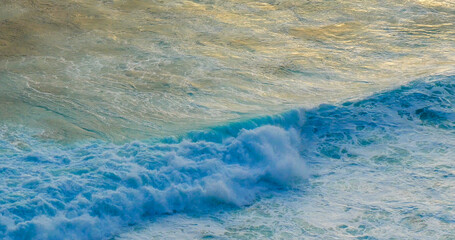 Wall Mural - Turquoise ocean sea water white wave pattern splashing deep blue sea. Seascape dark ocean background wave splash on rock. Tropical sea beach in summer seaside outdoor. Water Surface blue wave pattern