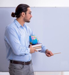 Sticker - Young male geography teacher in front of whiteboard