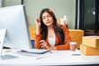 © NanSan - A businesswoman sits at the table, stressed as she works to sell products online. Sales are poor, losses mount, the market is quiet, customers disappear, and targets are not reached.