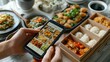 © ifoto - Close up of hand using a mobile phone to order fast food on an app