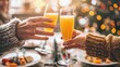 © ChanaphaStudio - Two people clinking glasses of orange juice in a cozy, festive setting, with holiday lights and decorations in the background.