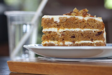 Carrot cake in plate on table at cafe