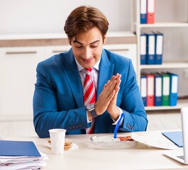 Wall Mural - Man having meal at work during break