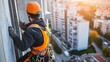 © 69 - Construction worker climber wearing safety gear, working at height on a construction site, emphasizing safety and precision