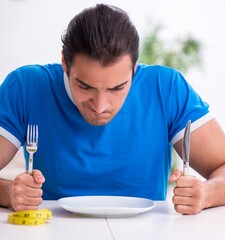 Young hungry man in dieting concept