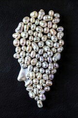 Poster - A bunch of pearls in the shape of a woman's head on a black surface