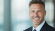 © Isaac - A professional headshot of a businessperson in a modern office setting, with a confident smile and formal attire.