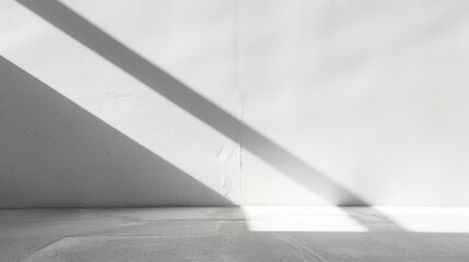 Aufkleber - A diagonal beam of sunlight illuminates a corner of a room, creating a strong, sharp shadow on the white wall and floor.