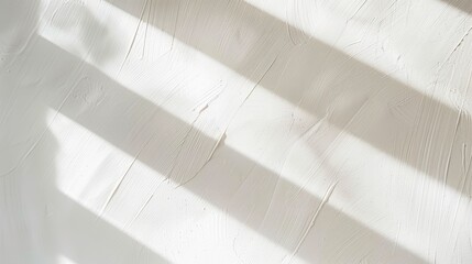 Aufkleber - Sunlight streams through a window, casting long, diagonal shadows on a white wall. The light creates a pattern of stripes, adding texture and depth to the smooth surface.