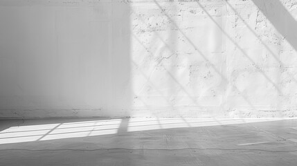 Aufkleber - The image shows a wide shot of an empty room, with a concrete floor and a white wall. Light from an unseen window is casting long, diagonal shadows on the floor and wall.