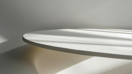 Poster - A close-up view of a round, white tabletop. The surface is smooth and polished. Light streaks across the table from the sun shining through a nearby window.
