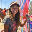 © Dot - American teen painting a mural on a community wall