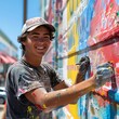 © Dot - American teen painting a mural on a community wall