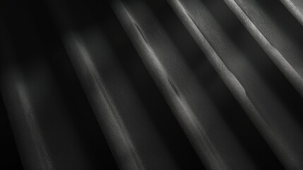 Leinwandbilder - The image shows a close-up of a dark surface with diagonal ridges, with the light catching the texture of the surface. The ridges are slightly uneven and create a sense of depth and dimension.