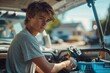 © cochisevisuals - Young man looking out of the back of a car, packing his fishing gear.