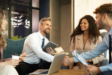 Poster - Businessmen shaking hands during a meeting.