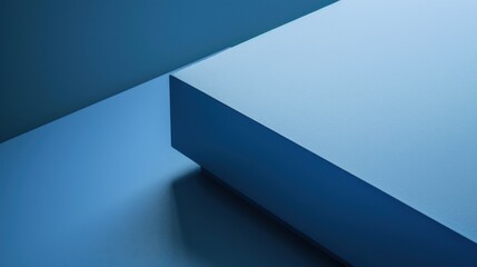 Fototapete - A close-up image of a simple geometric composition with blue hues, featuring a large, rectangular prism casting a shadow on a flat surface. The background is made up of soft blue tones, creating a sen