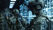 © vadosloginov - A soldier in a camouflage uniform is using a digital device. They are wearing a helmet and have a tactical vest. In the background, there are other soldiers and a wall with glowing blue screens.