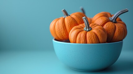 a banner design featuring decorative orange pumpkins on a pastel blue background, suitable for both 