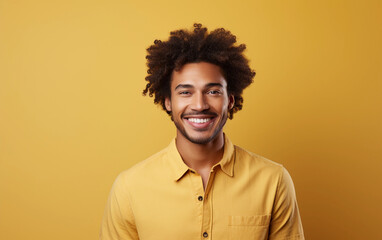 Wall Mural - A man with a big smile on his face is wearing a yellow shirt. He is posing for a picture and he is happy