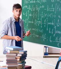 young male student studying math at school