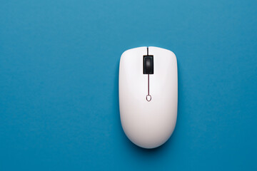 computer with mouse in blue on . business design hand concept. wireless mouse in blue and white on a