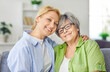 © Studio Romantic - Smiling loving senior older mature mother and grown daughter close embracing, caring young woman with aged mom having fun on happy international women day, spending mother holiday day at home