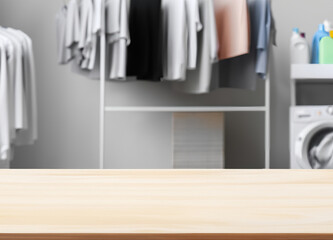 Wall Mural - Wood table for display products on background of blurred laundry room