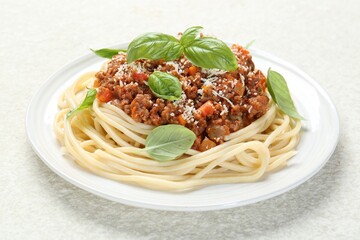 Wall Mural - Tasty pasta bolognese with basil on white table, closeup