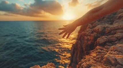 Wall Mural - Hand Reaching Towards the Sunset Sea