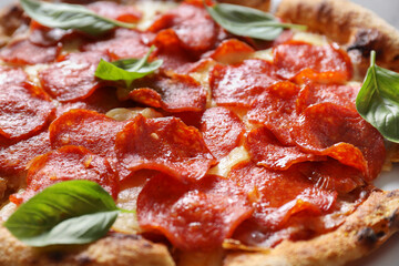 Wall Mural - Tasty pepperoni pizza with basil on table, closeup