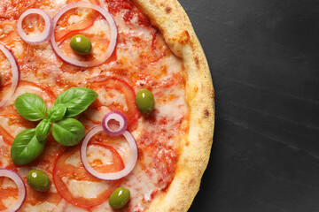 Wall Mural - Delicious vegetarian pizza on black table, top view