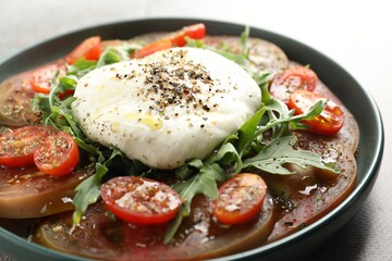 Wall Mural - Delicious fresh burrata salad in bowl on gray table, closeup