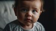 © Nemanja - Close-Up Portrait of Curious Baby with Blue Eyes in Soft Light and Casual Clothing
