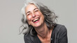 © Alina Tymofieieva - Portrait of a happy gray-haired woman having fun on a light gray background. Beauty, fashion concept.