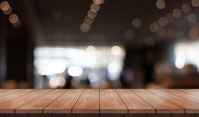 Wall Mural - Empty wooden table top with lights bokeh on blur restaurant background