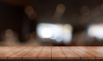 Wall Mural - Empty wooden table top with lights bokeh on blur restaurant background