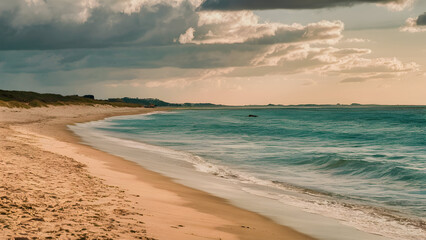 A sandy beach with gentle waves lapping