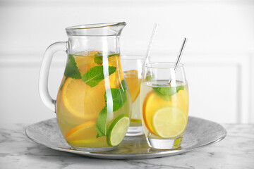 Poster - Freshly made lemonade with mint in jug and glasses on white marble table