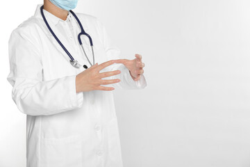 Wall Mural - Doctor holding something on white background, closeup. Space for text