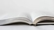 © Shozib - Open book resting on a white surface, inviting exploration of literature and knowledge