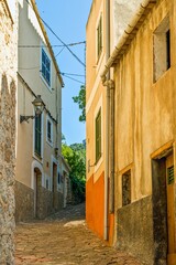 Image of a deserted street in a historic Spanish village at daytime