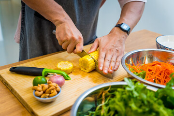 Chef at the kitchen preparing spicy glass noodle salad